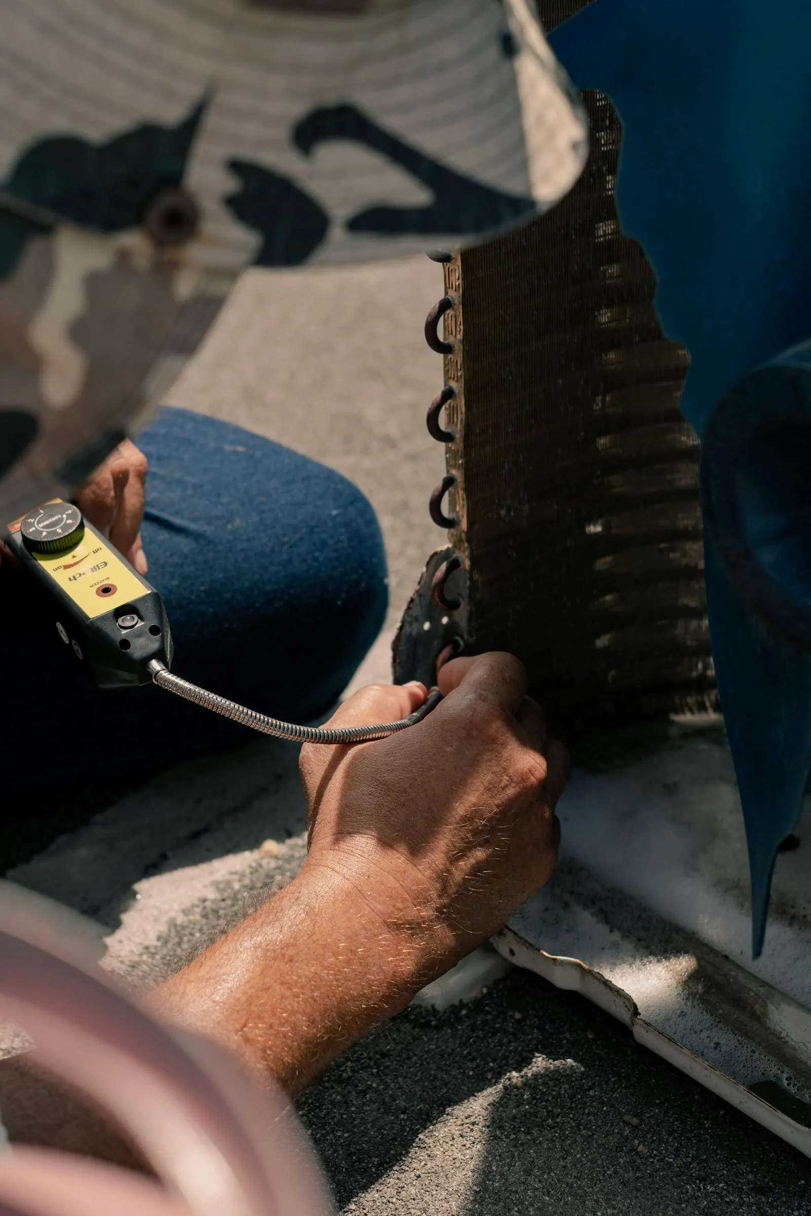 Close-up HVAC repair work on an air conditioning unit
